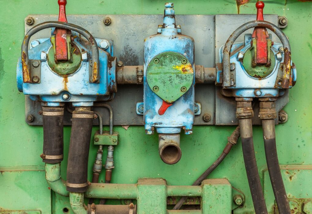 Close-up of aged and corroded industrial machinery showcasing rusty valves and pipes.